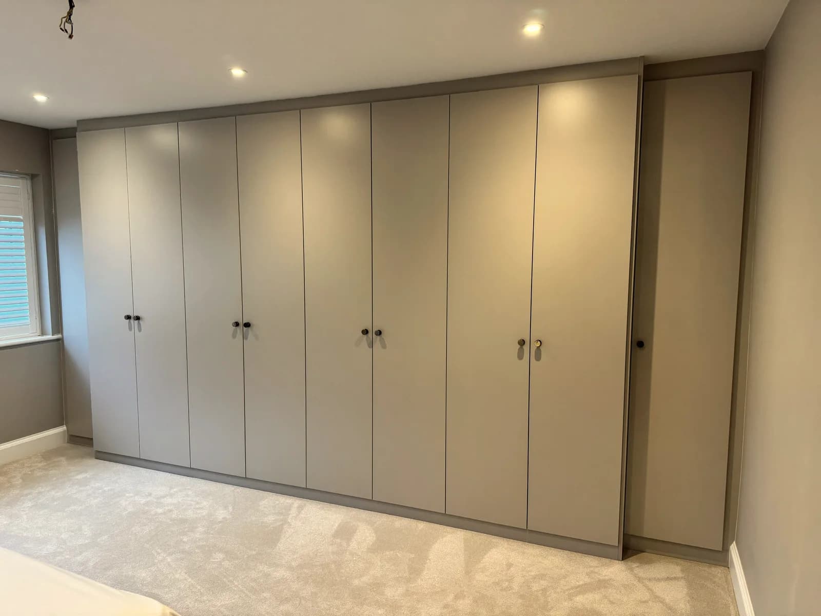 Elegant Cream Fitted Wardrobe with Brass Hardware
